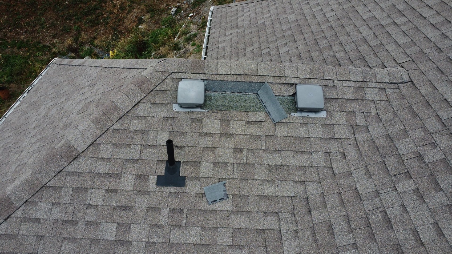 Aged and weathered asphalt shingle roof on a Chilliwack home being assessed for rejuvenation or replacement