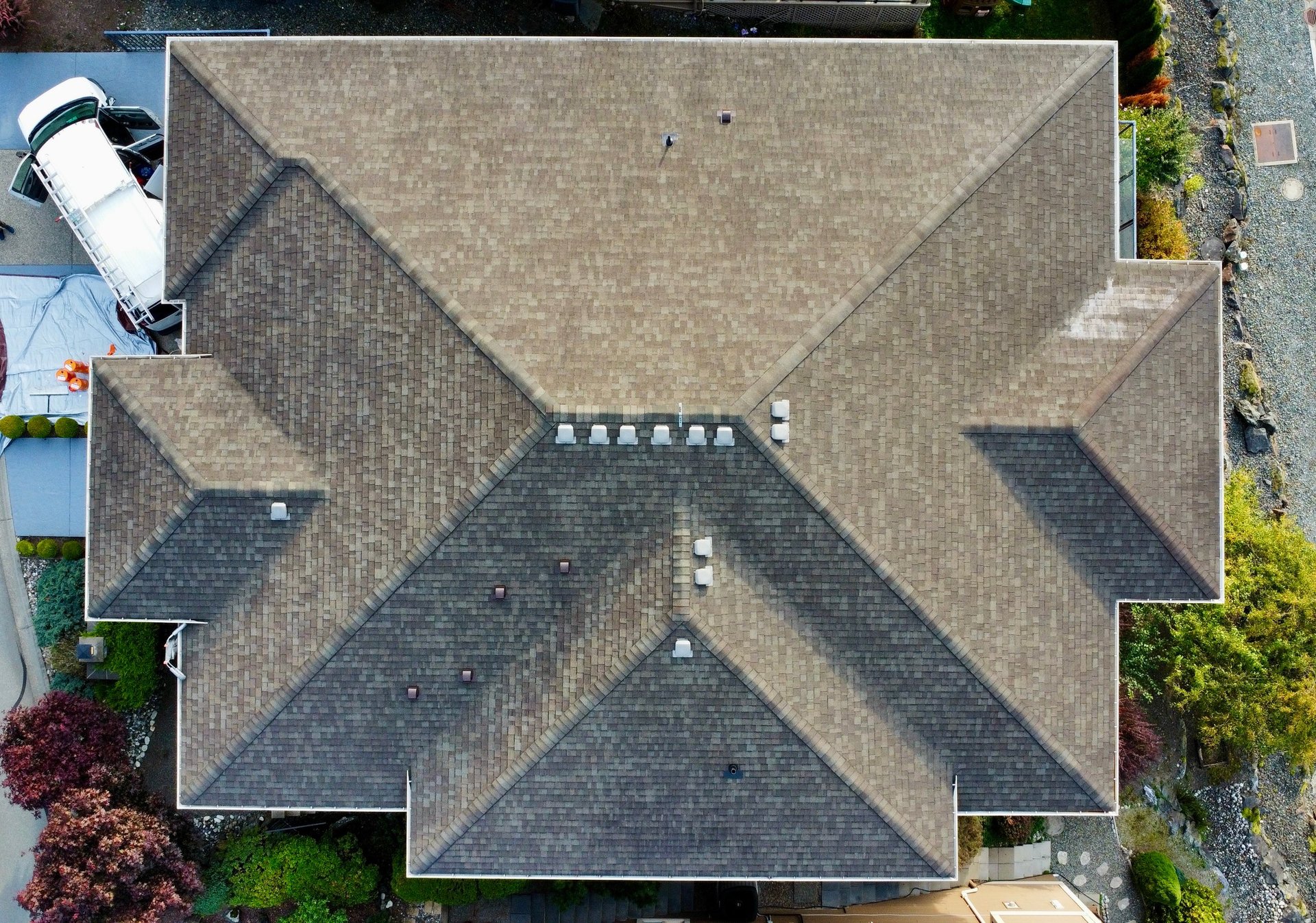 Completed GoNano roof treatment on a Chilliwack home, showing restored dark shingles